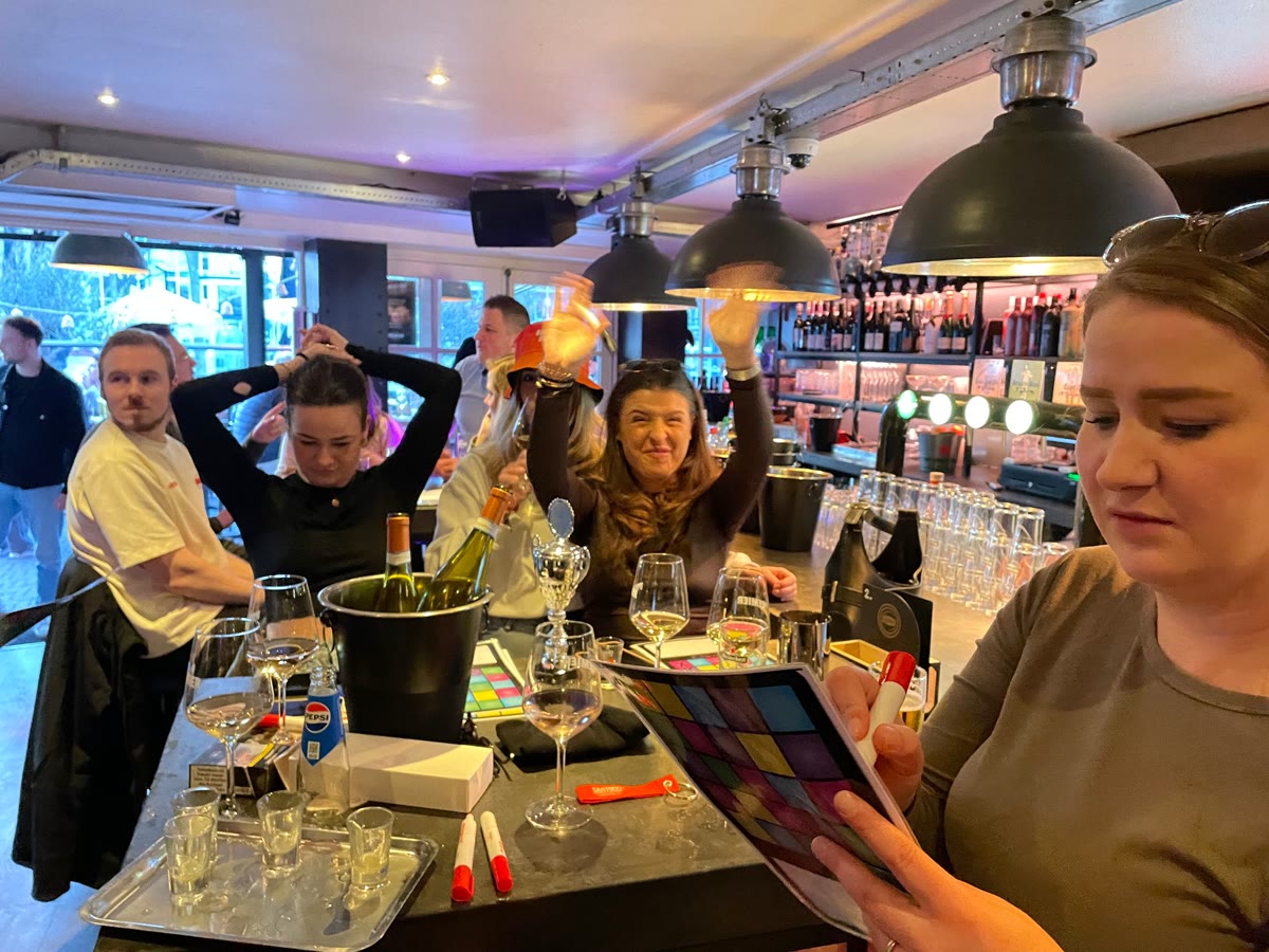 Gasten aan tafel binnen bij Café Premier